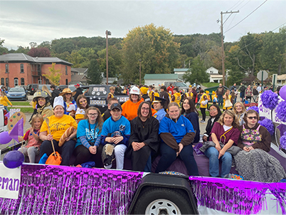 Students and adults on the homecoming float